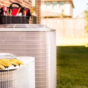 Work gloves and tools on top of air conditioning units